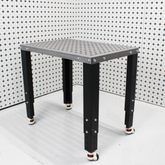 Light Duty Fixture Fabrication Table and Workbench against a patterned wall.